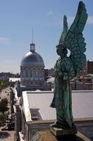 A statue of an angel looks out across the Bonsecours Basin from the top of the Notre Dame de Bon Secours Chapel in the old town of Montreal, Quebec, Canada.