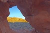 A peek a boo view of the landscape in the Valley of Fire State Park in Nevada, USA is seen here through Arch Rock, a must see stop during a visit to the park.