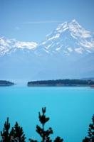 Beautiful Lake Pukaki stretches out before Mt Cook and the Southern Alps in the Mackenzie Basin in Canterbury on the South Island of New Zealand. The blue of the lake with the blue of the sky almost blends perfectly in to one amazing canvas of scenery.