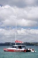 After sailing in the Bay of Islands off the North Island of New Zealand the Carino, the fifty foot catamaran sailing boat, anchors in Motuarohia (Roberton) Island.