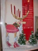 A statue of a moose adorned in Christmas decorations in a shop window in the old town of Regensburg in Bavaria, Germany.