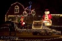 A bright christmas display with lights and inflatable characters in Utah, USA.