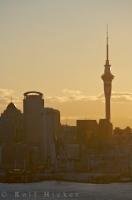 A section of Auckland City including the Sky Tower forms an imposing silhouette against the sunset as seen from the Mount Victoria Reserve and Lookout, situated in the suburb of Devonport on the North Shore, New Zealand.