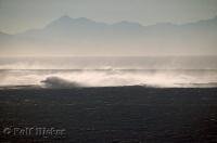 High waves pound the south jetty at the mouth of the Columbia River, seen from Cape Disappointment in Washington, USA.