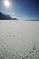 The salt flat of Badwater Basin are bright in the desert sun in Death Valley, California.
