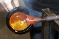 A glass blowing demonstration  using molten glass at a temperature of 900 degree F at the Lincoln City Glass Center in Oregon, USA.