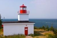 The Long Eddy Point Lighthouse, also know as The Whistle stands atop the rock cliffs in Grand Manan, New Brunswick in Canada.