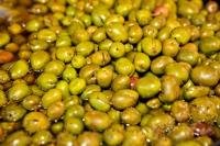 A mass of green olives on display at a market stall in the old city of Cordoba in the Province of Cordoba in Andalusia, Spain.