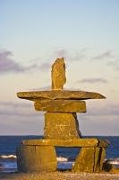 Along the shore of the Hudson Bay in Churchill, Manitoba at sunset, an Inukshuk has been built which is a symbol to the Inuit people. An Inukshuk was once, and in some instances today, an important landmark to the lives of many travelers.