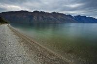 The water laps at the shores of the third largest lake in New Zealand, Lake Wakatipu on the South Island.