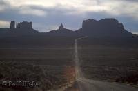 The highway disappears between the rock formations of Monument Valley in Utah, USA.