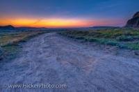 This arid farmland is found in the Big Muddy Badlands located in Southern Saskatchewan and as the sun sets on another day the sky is turned to various shades of pinks, yellows and blues. This area also borders nothern Montana.