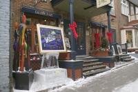 Joining in the spirit of the Quebec Winter Carnival, an art gallery features a painting on an ice sculptured easel.