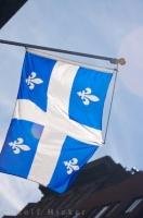 The blue and white provincial flag of Quebec, is an enduring symbol of France which features four Fleurs-de-lys translated from french as lily flowers.