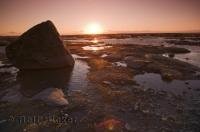 A beautiful sunset reflects off the low tide pools of the St Lawrence River along the coast of Quebec, Canada a romantic vacation spot.