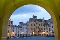 Dusk sets on the buildings, cafes and restaurants in the old Roman Amphitheatre in the Piazza Anfiteatro, which is located in the city of Lucca, in the Province of Lucca, the Tuscany Region of Italy. The Roman Amphitheatre dates back to 180 BC.