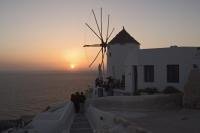 A classic shot of Santorini, a windmill with a romantic sunset