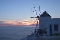Photo of the famous windmill in Oia on Santorini Island.