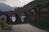 The Serchio River Bridge is called Ponte della Maddalena and spans the river near Borgo a Mozzano, a village in Lucca, Italy.