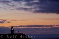 Magical hues fill the sky at sunset over Cape Reinga Lighthouse on the North Island of New Zealand after another beautiful day along the coastline.