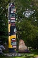 Under the lush green trees, a beautiful Kwakiutl Totem Pole is displayed on the grounds of the Manitoba Legislative Building in Winnipeg.
