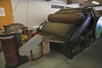 A carding machine on display at the Agrodome in Rotorua, is used to disentangle, clean, and mix wool fibres into a sliver, a form which is then suitable for further processing.