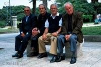 Italian men sitting on a bench in Otranto in Lecce, Italy