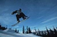 A jumping snow boarder on Whistler Mountain in British Columbia, Canada