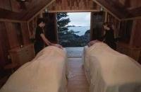 A couple enjoying a relaxing massage with a view out to the sea