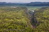 From an aerial perspective, Ouimet Canyon appears like a giant tear in the forested landscape of Ontario, Canada. Situated in the Ouimet Canyon provincial park, the canyon was named after a railway station which was once located nearby.