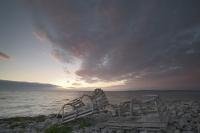 A beautiful sunset is reflected on the clouds above the Atlantic Ocean in the Strait of Belle Isle, Newfoundland.