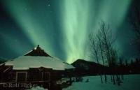 Northern Lights (Aurora borealis) in winter above a old goldrush cabin