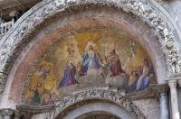 An elaborate painting adorns an archway of the grand Basilica San Marco in the popular tourist destination of Venice, Italy, Europe.