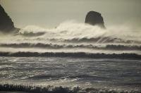 A row of waves with the biggest wave at the back roll in along the coast of Oregon in the USA.