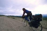 A fully loaded biker travels the Dempster Highway in the Yukon Territory of Canada.