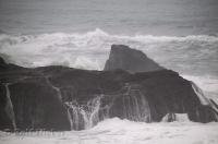 The water trickles off the rocks after being pounded by the Pacific Ocean along the Coast of California, USA.