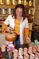 A woman demonstrating the art of candlemaking at the Candle Making Workshop in the village of Gourdon in the Provence, France.