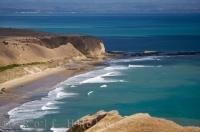 The constant waves of the Pacific Ocean wash along the coast of Cape Kidnappers as seen from the Australasian Gannet Colony in Hawkes Bay on the East Coast of the North Island of New Zealand. This area has an interesting name and its own place in history.