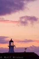 The sunset creates stunning colors in the sky at the Cape Reinga Lighthouse on the North Island of New Zealand.