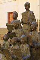 A statue of a choir stands opposite the Guadix Cathedral in the town of Guadix in the Province of Granada in Andalucia, Spain.