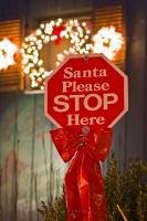 With Christmas lights blazing in the background ... a funny stop sign is posted in front for Santa to see. It reads: Santa Please STOP Here.