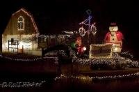 A brighly decorated house with christmas characters and lights.