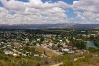Under fluffy white clouds sits the town of Clyde and the Clutha River in Central Otago on the South Island of New Zealand.