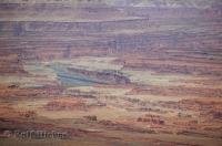 The brilliant blue of the Colorado River contrasts against the red rock landscape in Canyonlands National Park in Utah.