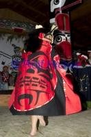 A  Barefoot Dancer twirls in a Cloak decorated with Indian symbols.