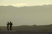 A couple enjoy sunrise in Death Valley National Park in California, USA.