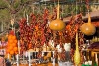A display of dried chili peppers hanging in decorative bunches on the road to Guadalest in the Province of Alicante in the Comunidad Valenciana in Spain.