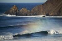 The Pacific Ocean reflects a beautiful rainbow below Chapman Point in the Ecola State Park in Oregon, USA.