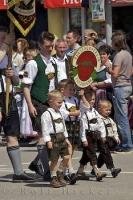 The children at a European festival walking with a local sign in Putzbrunn, Southern Bavaria, Germany.