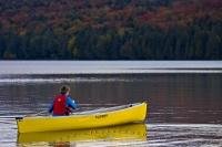 A popular form of outdoor recreation at Algonquin Provincial Park is paddling a canoe along the scenic shores of Rock Lake, surrounded by the stunning colors of fall.